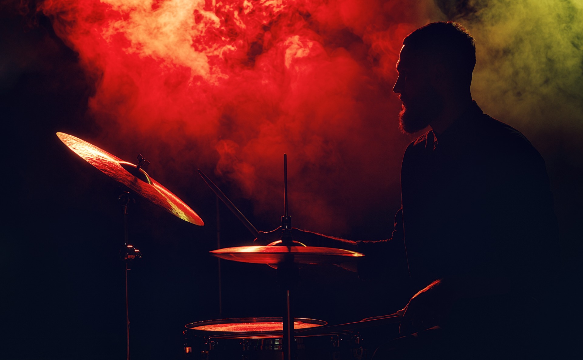 Drummer performing at a gig on a silhouette camera shot